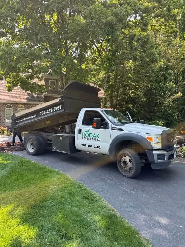 A landscaping company truck on a residential job
